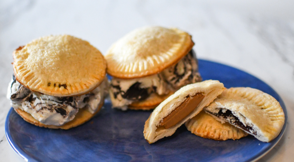 Two Moose Tracks hand pies sitting on a blue plate.