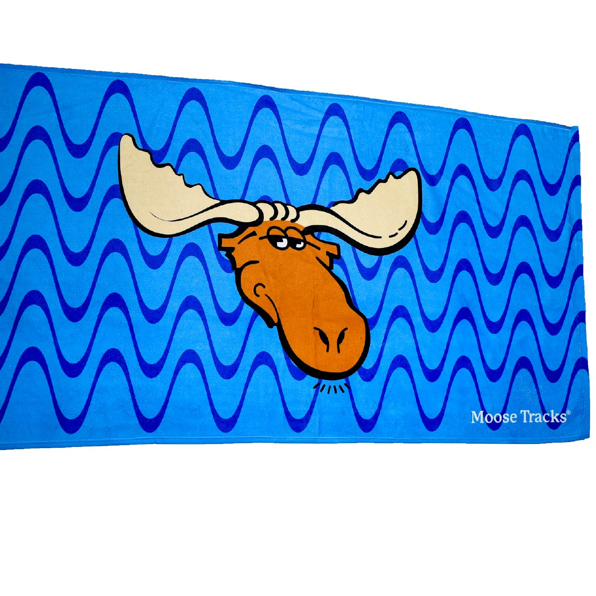 The Moose Tracks Beach Towel laying a flat surface with the design facing the front. The towel is bright blue with dark and light blue wavy lines in the background. The center of the towel features the Moose Tracks logo, and the bottom right corner has "Moose Tracks" printed in white.